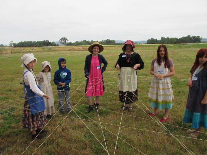 kids make a big web with ball of yarn singing creek center oregon