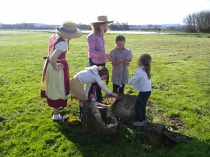 homeschool kids investigate nature on a log