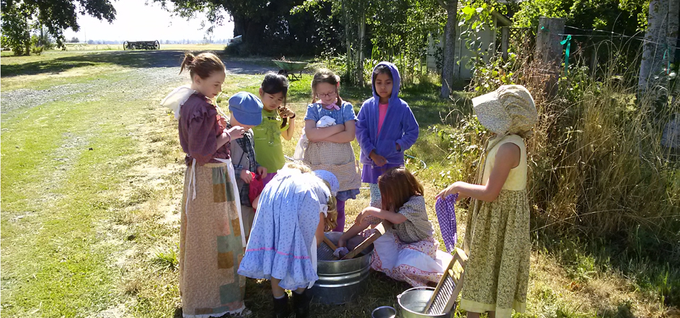 children washing clothes by hand