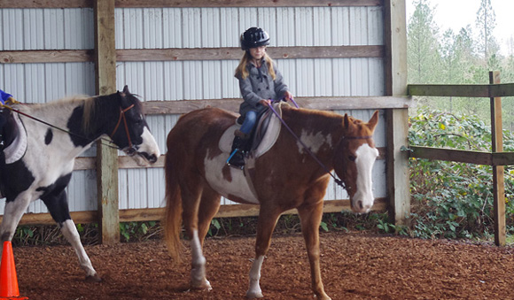 pioneer child riding horse singing creek center kids activities