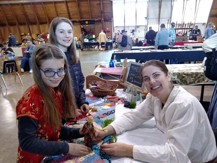 girls making corn dolls frontier heritage fair eugene oregon