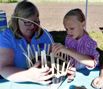 volunteer basket maker with child singing creek educational center