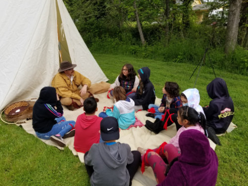 trapper teaching kids at a field trip at Singing Creek Educational Center