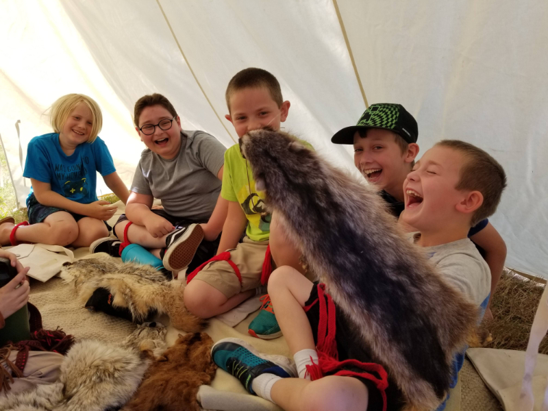 kids having fun playing with animal furs at SCEC summer camp kids playing with furs at summer camps
