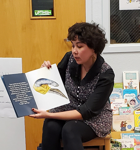 Sam reading a story to kids in the library Indigenous culture