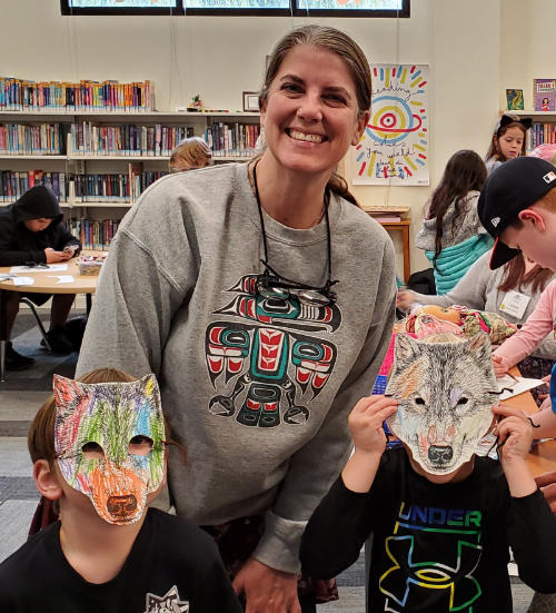 kids in a library making wolf mask with paper
