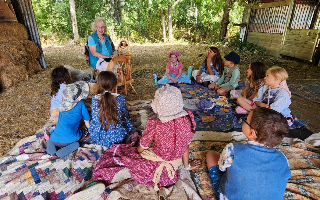 Ann spinning at summer camp with children
