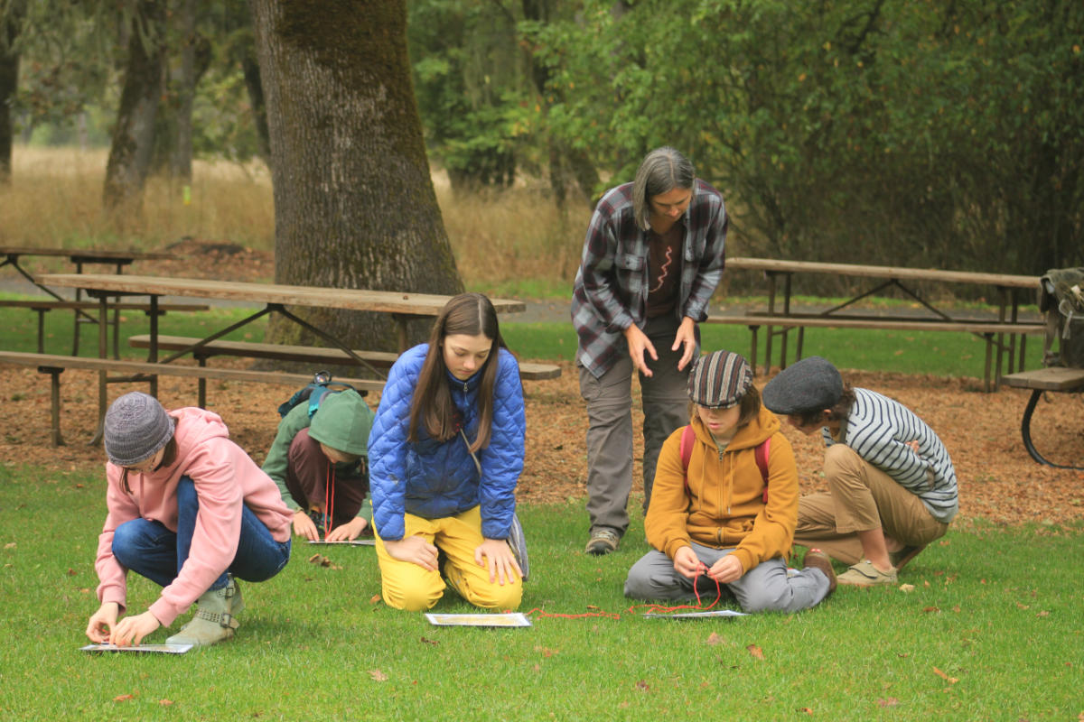 Jess with kids working on map and compass