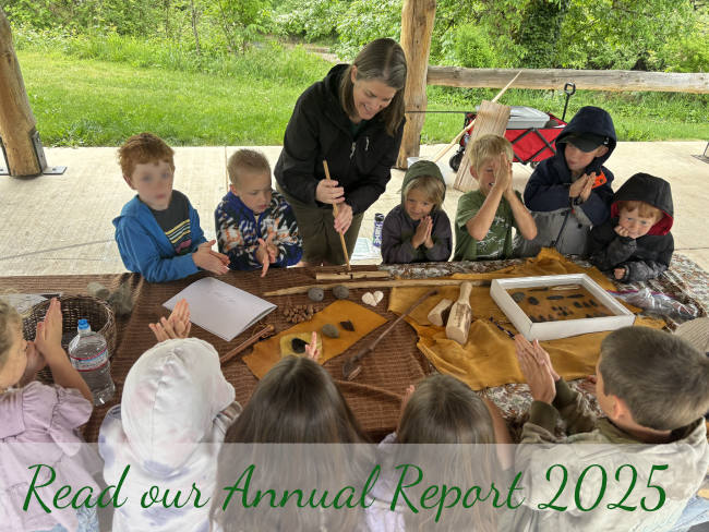 Karen shows friction fire to kids- Read our annual report