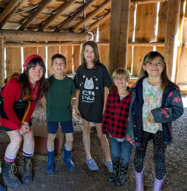 Willow and young students in the indigenous plankhouse at Dorris Ranch