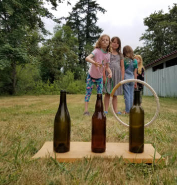 girls throwing rings at summer camp 
