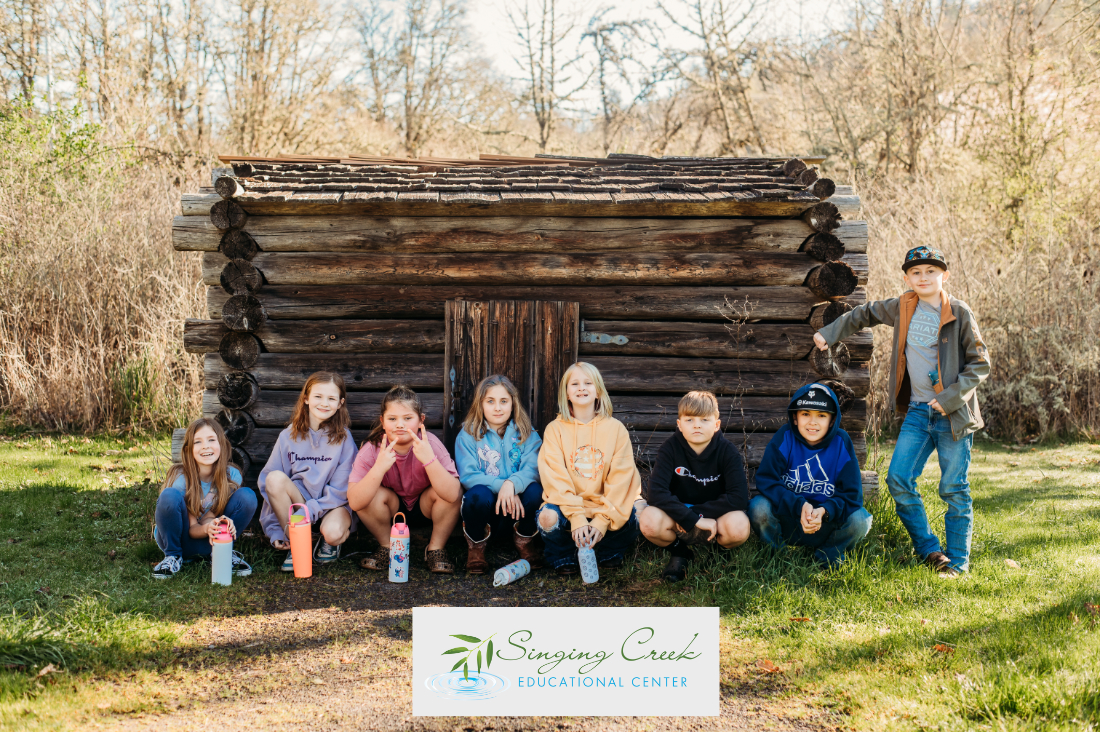 kids by the fur trappers cabin field trip